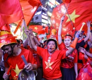 Vietnamese flood streets to celebrate historic football victory