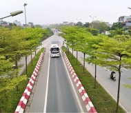 Green trees enhance the beauty of modern intersections in Hanoi